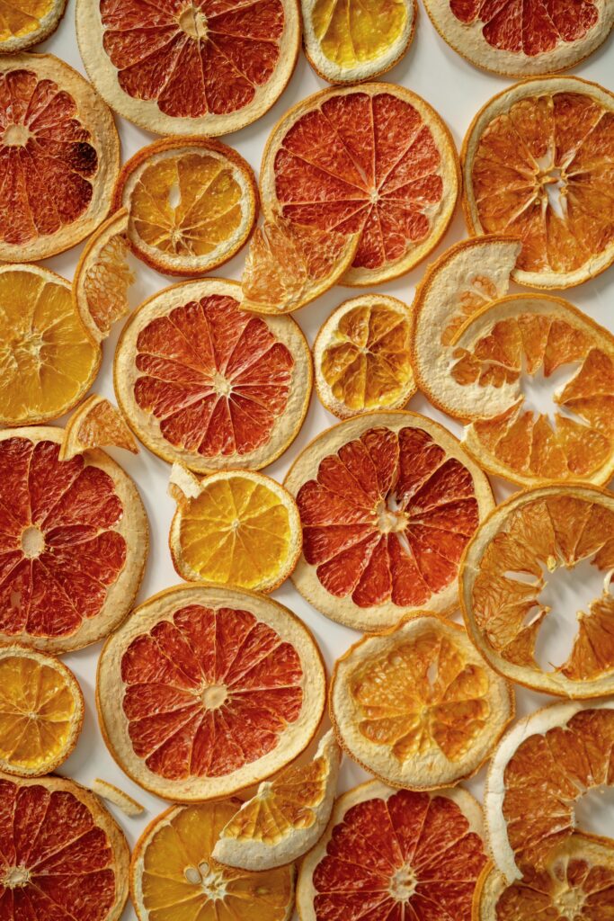 Bright and vivid dried citrus slices creating a textured background, perfect for food and nature themes.